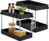 Two black two-tiered storage shelves with silver legs, one slightly behind the other, are shown against a white background. The shelves contain various items like bottles of oil, a small potted plant, a jar of brown granular material, and a packaged food i Náhled obrázku produktu