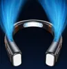 A close-up shot of a black and gray neck fan with blue light trails emanating from it. Produktbild-Vorschau
