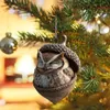 A close-up of an owl ornament shaped like an acorn, hanging on a Christmas tree. Produktbild-Vorschau