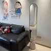 A living room scene with a black leather sofa, stuffed toys, and a tall oval mirror. Produktbild-Vorschau