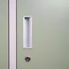 A close-up view of a green metal locker door with a silver handle and a keyhole. Produktbild-Vorschau