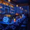 A bar decorated with blue string lights, with people sitting at the bar. Produktbild-Vorschau