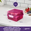 A pink Sistema lunch box filled with food, placed on a kitchen counter next to a plate of fruit. Podgląd zdjęcia produktu