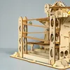 A wooden marble run construction kit with marbles on the tracks. Voir les images du produit