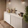 A modern living room with a beige sideboard displaying decorative items and artwork. Produktbild-Vorschau