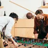 Two men playing foosball in a room. Náhľad obrázku produktu