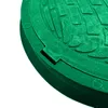 A close-up, angled view of a green manhole cover with a textured surface. Produktbild-Vorschau