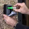 A person is applying lubricant to a key safe. Náhľad obrázku produktu