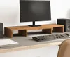 A monitor stand on a desk with a monitor, keyboard, and speakers. Podgląd zdjęcia produktu