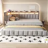 A modern bedroom setting featuring a grey upholstered daybed with a pull-out trundle bed, illuminated by LED lighting along the headboard. Náhled obrázku produktu