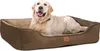 A golden retriever dog is lying in a brown dog bed.