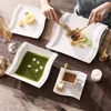 A table setting with plates of food, a cup of coffee, and a candle. Náhled obrázku produktu