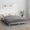 A bed with a gray weighted blanket is shown in a bedroom setting. Voir les images du produit