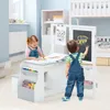 Two children are using a multi-functional art easel and desk set in a brightly lit room. Produktbild-Vorschau