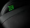A close-up view of a black gaming chair with green stitching and the word 'ZEN' embroidered in green. Podgląd zdjęcia produktu