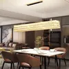 A modern dining room with a rectangular crystal chandelier hanging over a dining table. Náhľad obrázku produktu