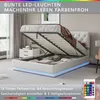 A white bed with its storage compartment open, showing the hydraulic lift mechanism and some stored items. LED lights are visible around the base of the bed. Produktbild-Vorschau