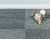 Two vases and some flowers are placed on a gray carpet. Produktbild-Vorschau