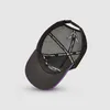 The underside of a black trucker cap with purple trim is shown against a light gray background. Produktbild-Vorschau