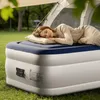 A woman sleeping on an air mattress in front of a tent outdoors. Anteprima dell’immagine prodotto