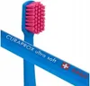 A close-up shot of a blue toothbrush with pink bristles. Náhled obrázku produktu