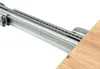 A close-up view of a metal drawer slide mechanism attached to a wooden surface. Produktbild-Vorschau