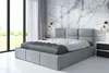 A modern bedroom with a large bed, marble accent wall, and large windows.