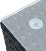 A close-up view of the corner of a black rattan furniture set with a glass top and a clear suction cup. Produktbild-Vorschau