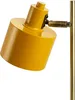 A close-up shot of a yellow desk lamp with brass accents, isolated on a white background. Produktbild-Vorschau