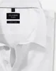 A close-up view of a white OLYMP brand dress shirt, showing the collar and label details. Produktbild-Vorschau