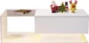 A white modern coffee table with a glass top and a book on it, decorated with small Christmas figurines. Voir les images du produit