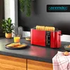 A red toaster with toast in it, sitting on a kitchen counter next to a glass of orange juice and a plant. Produktbild-Vorschau