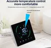 A smart digital thermostat is displayed on a table with some decorative items in the background. Podgląd zdjęcia produktu