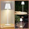 A collage of images showing a white LED table lamp in different settings: on a table indoors, on a table outdoors, and a close-up of its shade. Náhľad obrázku produktu
