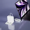 A white laptop charger is plugged into a wall socket and connected to a laptop. Produktbild-Vorschau