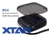 A product shot of a battery charger with its lid open, showing the battery slots. Text and a logo are present. Produktbild-Vorschau