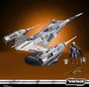 A Star Wars N-1 Starfighter toy set with figures of The Mandalorian and Grogu, displayed on a stand against an orange gradient background. Náhled obrázku produktu
