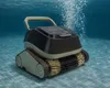 A pool cleaning robot is submerged in clear blue water, with bubbles rising from it. Produktbild-Vorschau