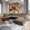 A modern living room with a large sectional sofa in the foreground and a kitchen and dining area in the background. Podgląd zdjęcia produktu