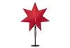 A red star-shaped lamp on a black stand against a white background. Podgląd zdjęcia produktu