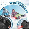 Two people are sledding down a snowy hill on sleds, with snow falling around them. Produktbild-Vorschau