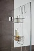 A shower caddy with bottles hanging on a glass shower door. Produktbild-Vorschau