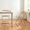 A dining set with a table and two chairs in a bright room. Produktbild-Vorschau