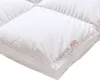A close-up, angled view of a white duvet with quilted sections. Náhled obrázku produktu