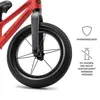 Close-up of the front wheel and fork of a red balance bike, with marketing icons and text on the right. Náhled obrázku produktu
