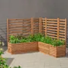 Two wooden planter boxes with trellises are arranged in an L-shape on a paved patio, with plants growing in them. The background is a textured gray wall. Anteprima dell’immagine prodotto
