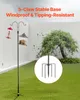 A bird feeder pole with two feeders is shown in a backyard setting, with a close-up of the pole's base. Produktbild-Vorschau