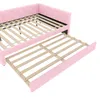 A pink upholstered daybed with a trundle bed pulled out, showing the wooden slat bases for both. Podgląd zdjęcia produktu
