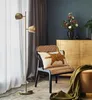 A living room scene with a floor lamp, chair, and cabinet. Produktbild-Vorschau