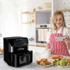 A woman in a kitchen is looking at a tablet while an air fryer is in the foreground. Náhľad obrázku produktu